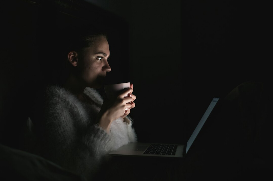 person using laptop at night